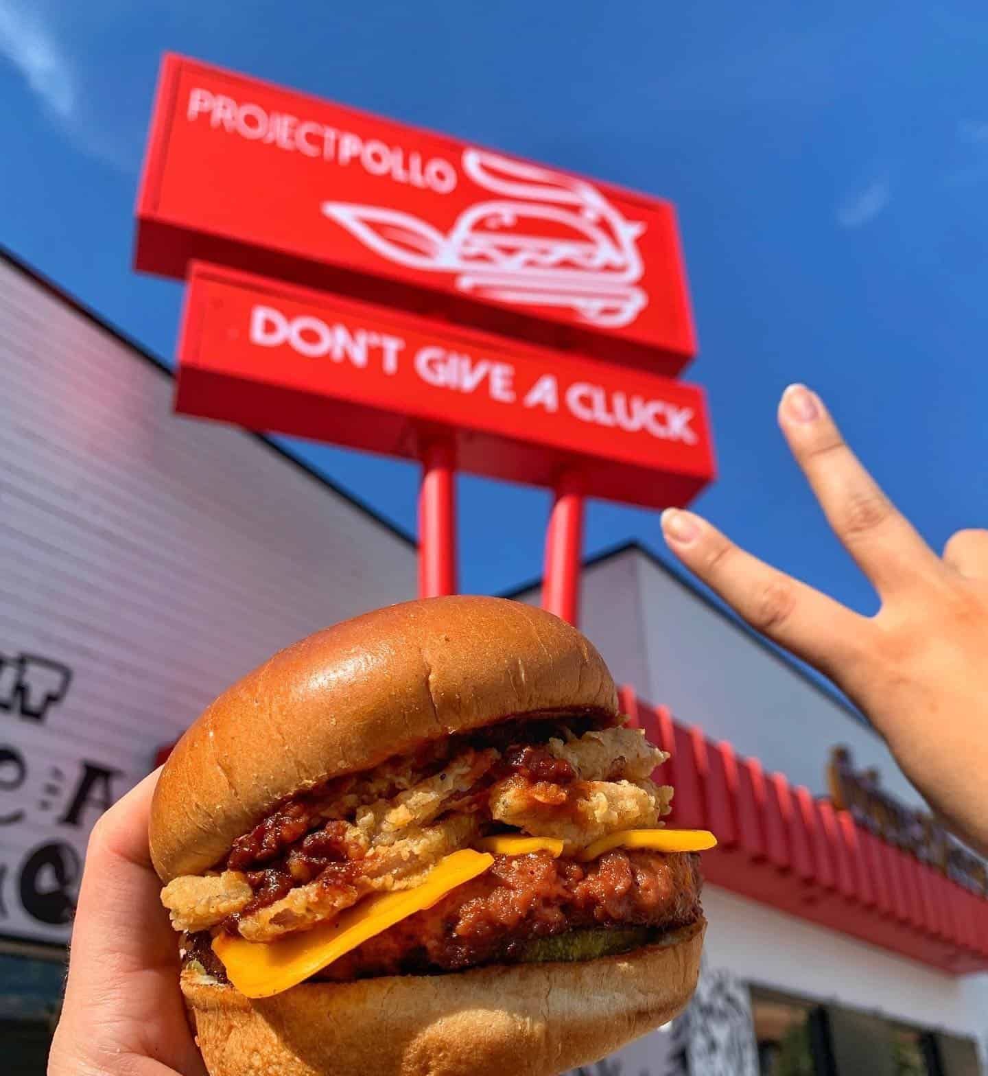Vegan Chikn sandwich in front of the iconic Project Pollo sign in San Antonio